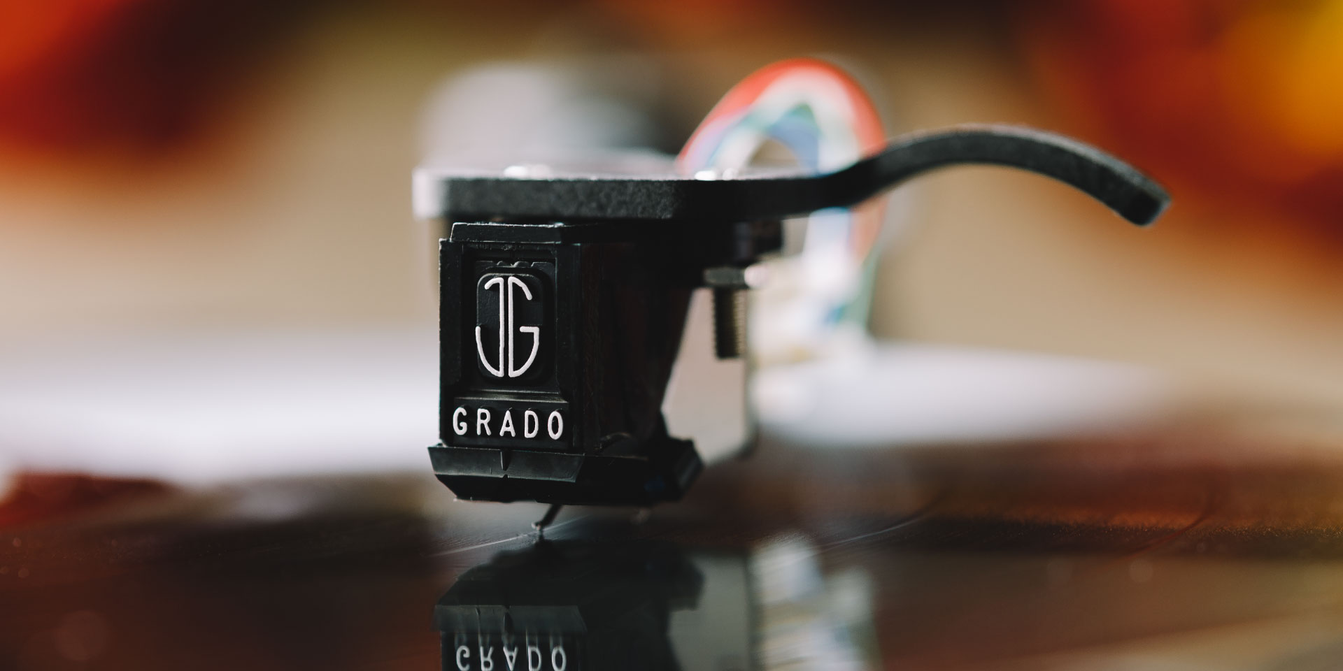 Photo of Grado phono cartridge playing a record with a blurred background