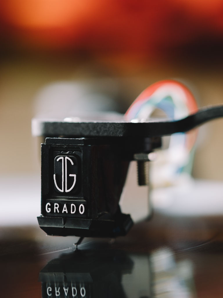 Photo of Grado Black3/Green3 phono cartridge playing a record with a blurred background