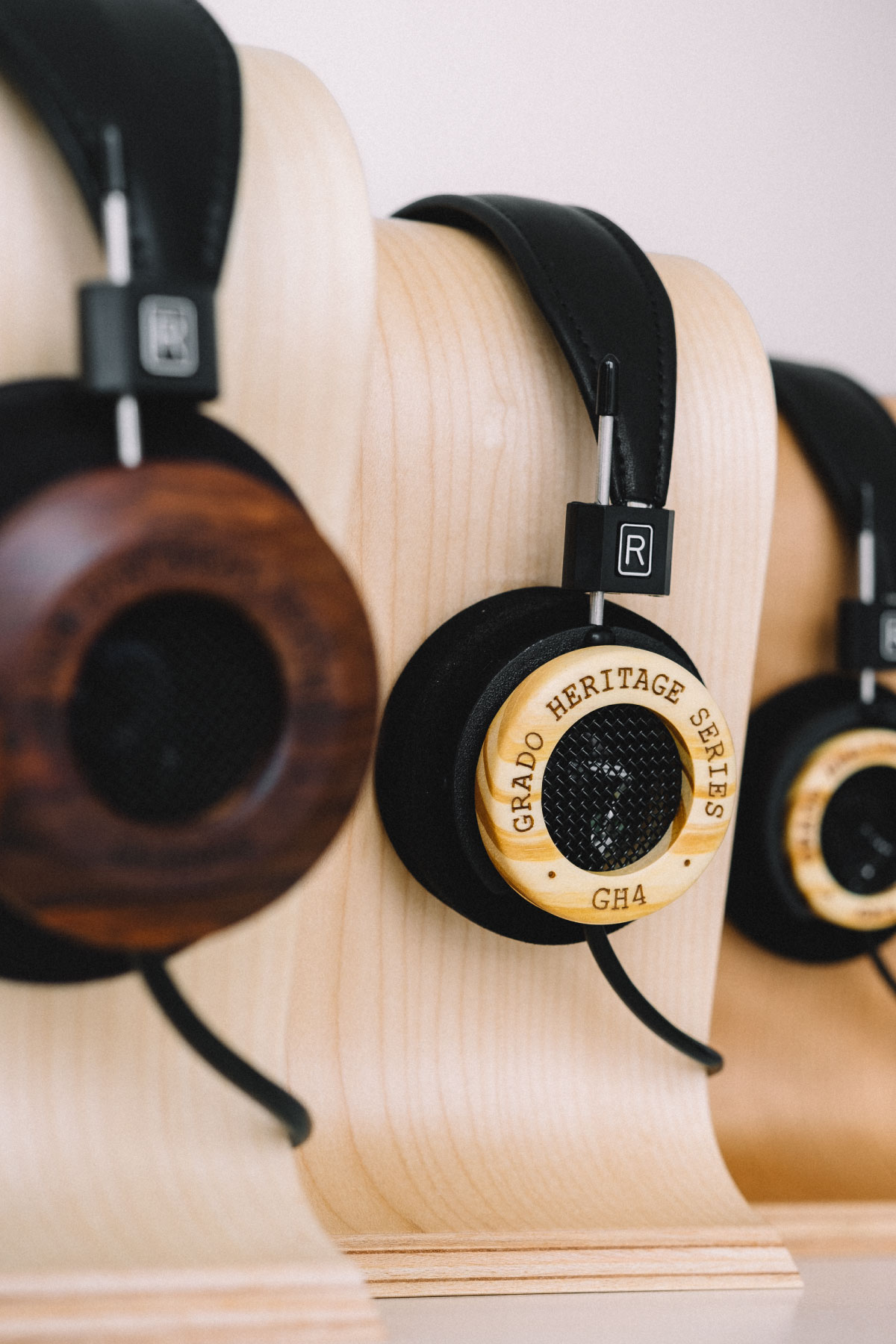 Photo of GH4 Headphones on headphones holder with other headphones on holders in the foreground and background