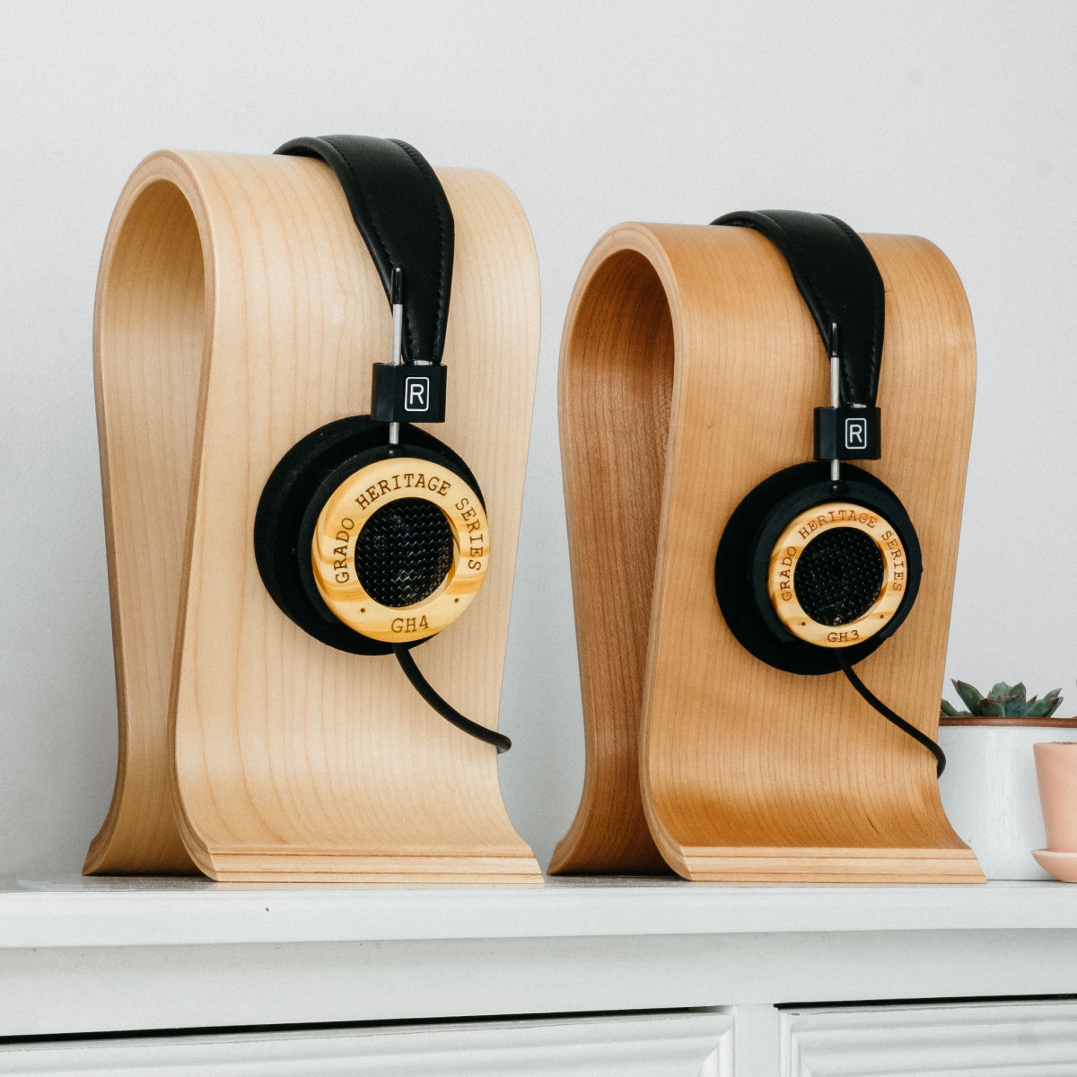 Photo of GH3 and GH4 headphones on wooden headphone stands