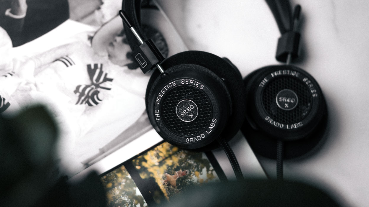 Photo of SR60x headphones taken from above, showing the headphones resting on an open photobook which is on top of a white marble table