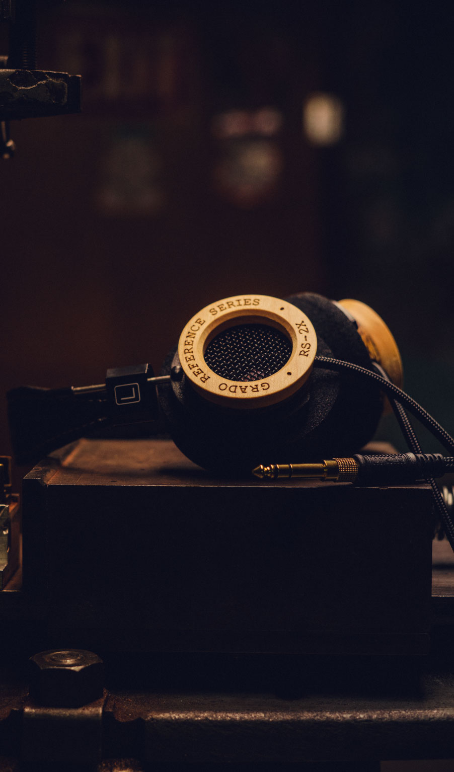 Photo of RS2X Headphones resting on a wooden box on a wooden table